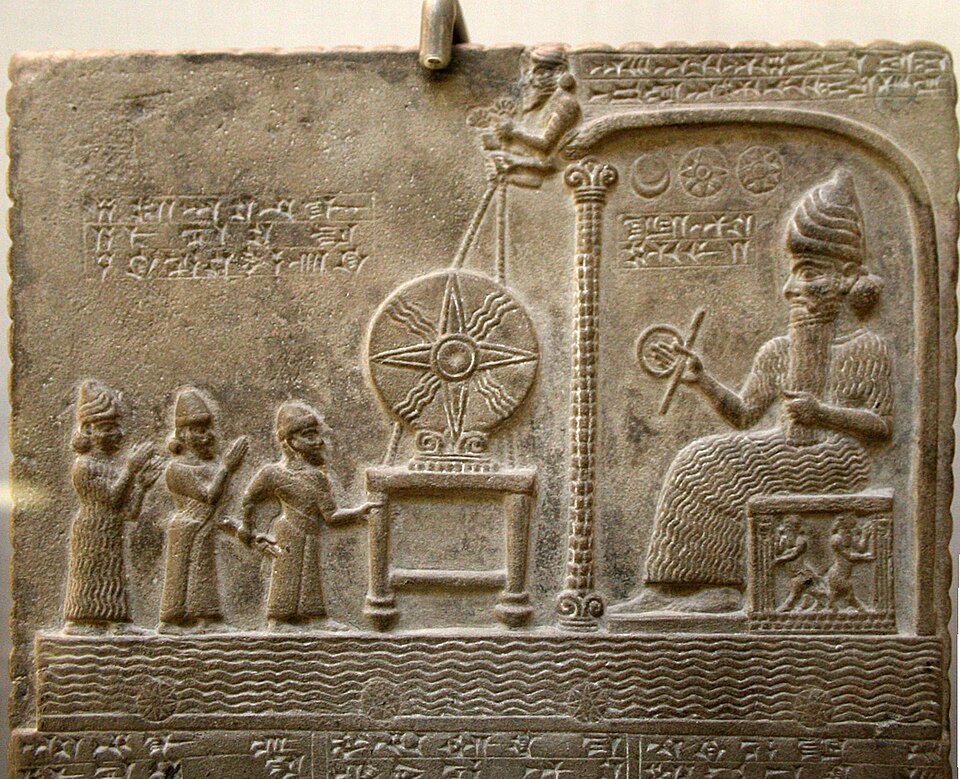 The Tablet of Shamash, a stone relief of the sun god seated on a throne, titled so on WikimediaCommons