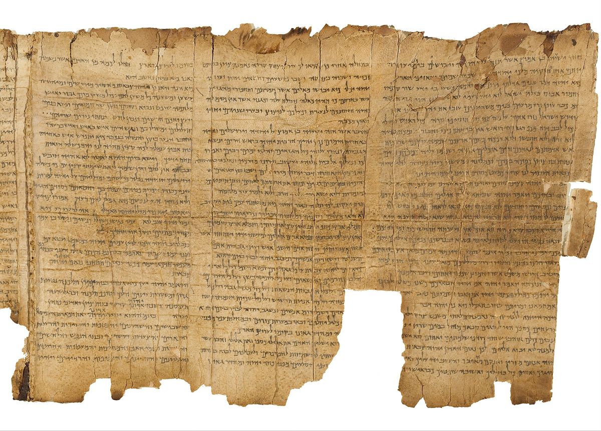Part of the Great Isaiah Scroll: columns of Hebrew writing on worn, torn tan leather.