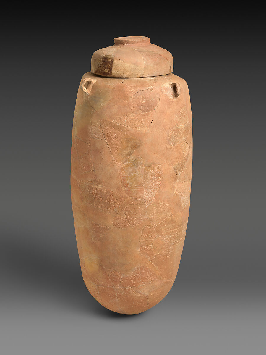 A tall, round clay jar with its lid, the kind of jar that held some of the scrolls.